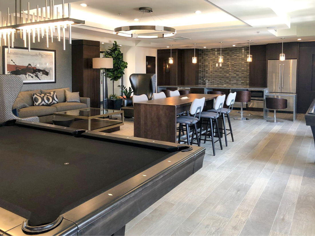 a living room with a pool table and a bar